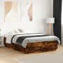 Bed frame with LED lights smoked oak wood 140x190 cm by , Beds and slatted bases - Ref: Foro24-3209643, Price: 165,36 €, Disc...